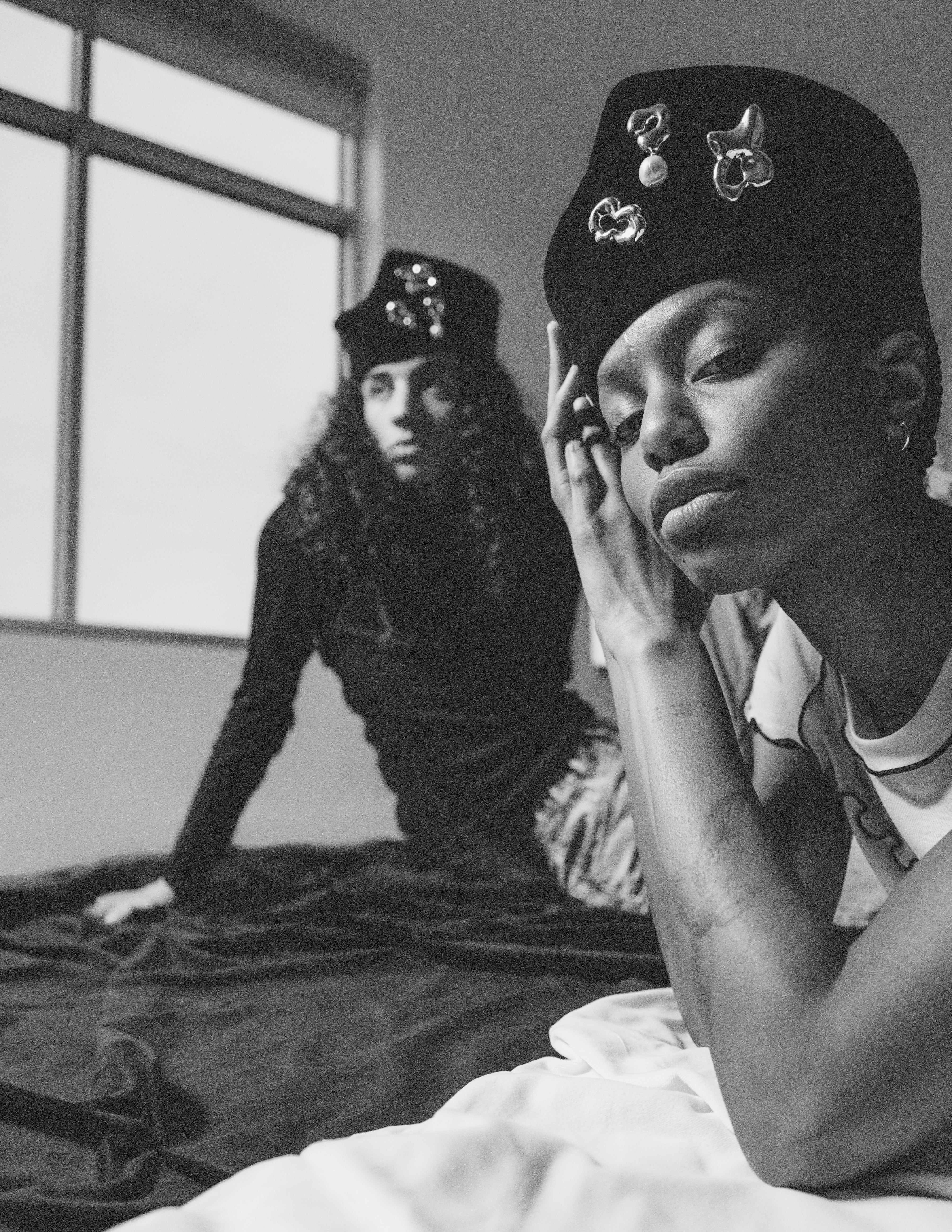 Image depicting two models wearing the structural hat with silver brooches by Heirloom Hats and Séola Atelier