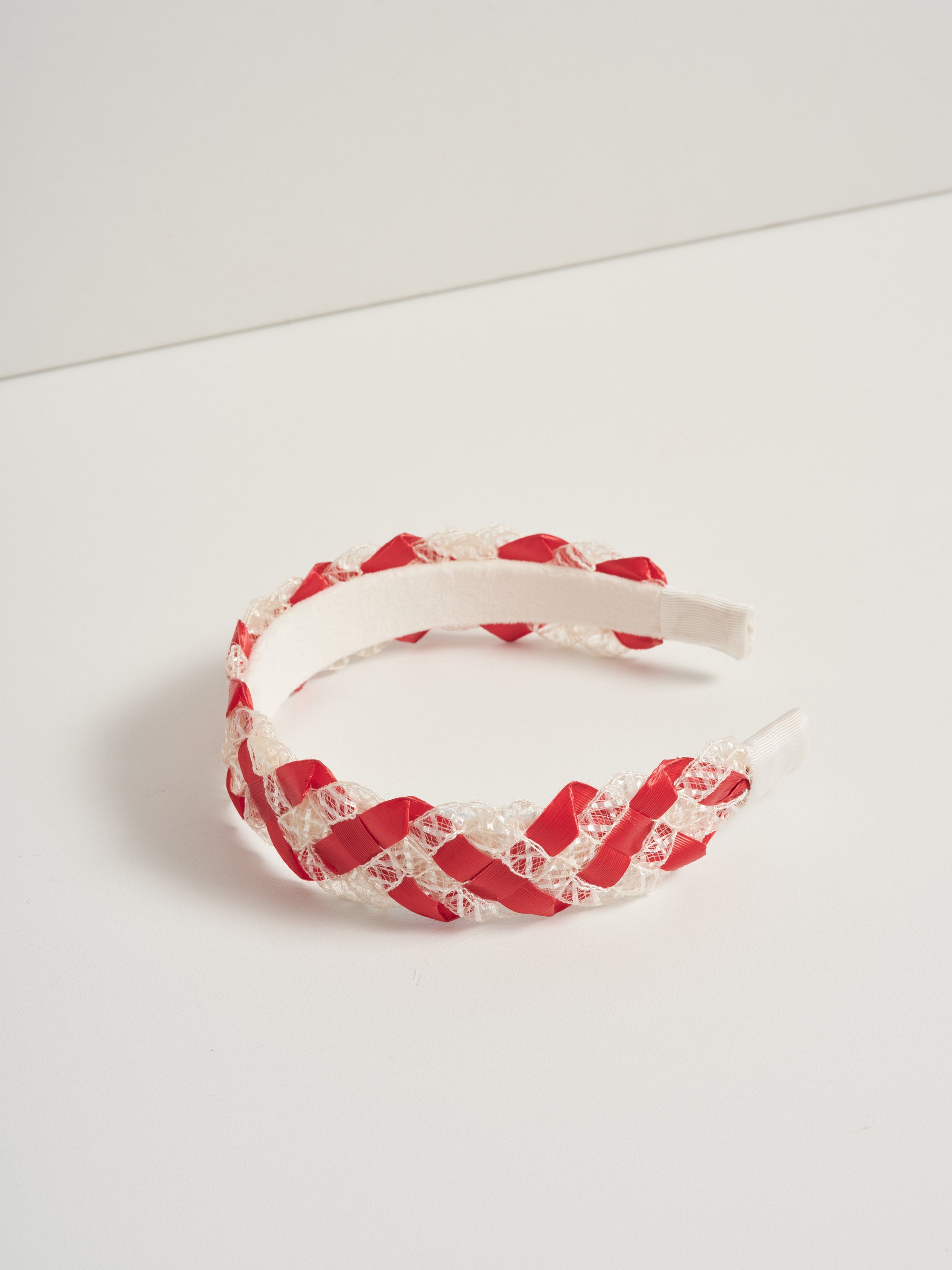 Red and white vintage straw headband pictured on a white background.